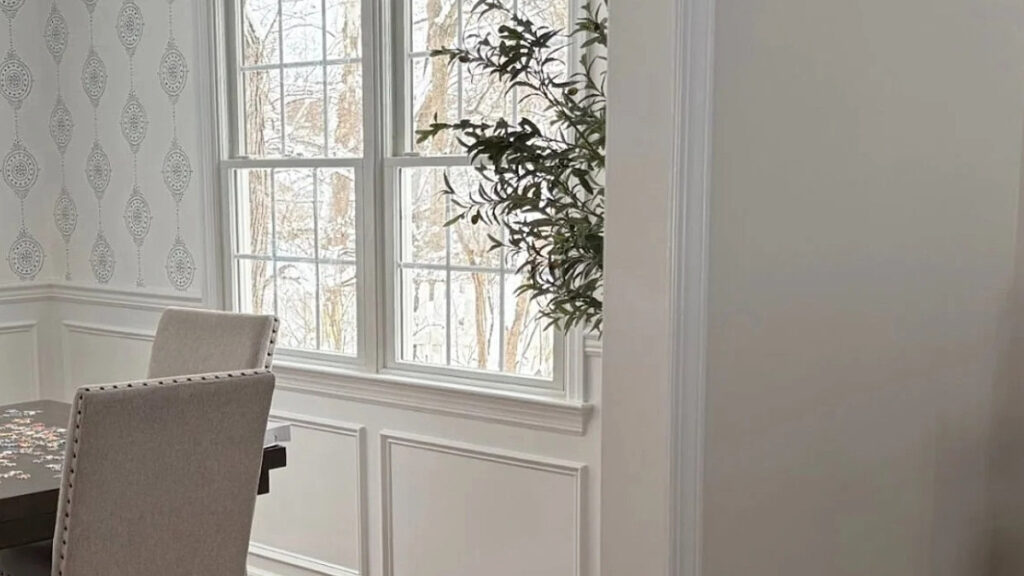 Benjamin Moore Decorator's White on wainscoting and panelling with wallpaper and natural lighting.