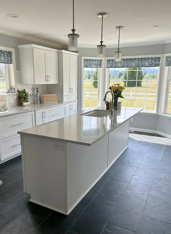 Benjamin Moore Silver Chain with factory white kitchen cabinets, gray quartz countertops, dark charcoal slate look tile floor, bay window, blue accent valance, subway tile