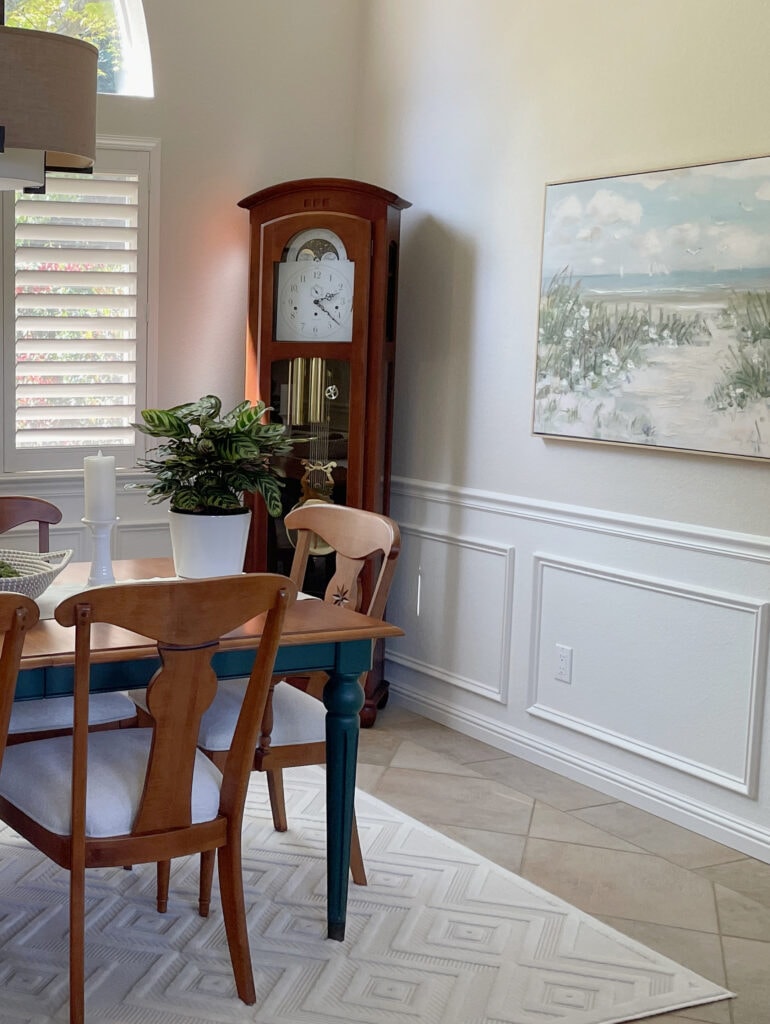 Dining room, red cherry wood furniture, beige tile floor, off-white beige wainscoting and trim, lightened Moderate White, Sherwin Williams Natural Linen on walls - popular beige paint color