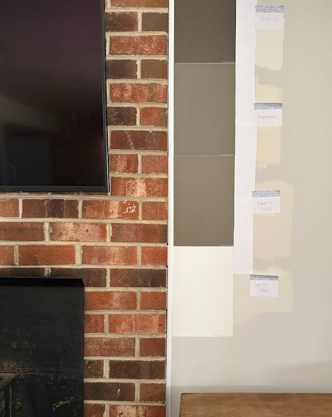 Sherwin Williams Anonymous versus Adaptive Shade, medium dark greige accent colors. POrpoise and BEnjamin Moore White Dove with red brick fireplace.