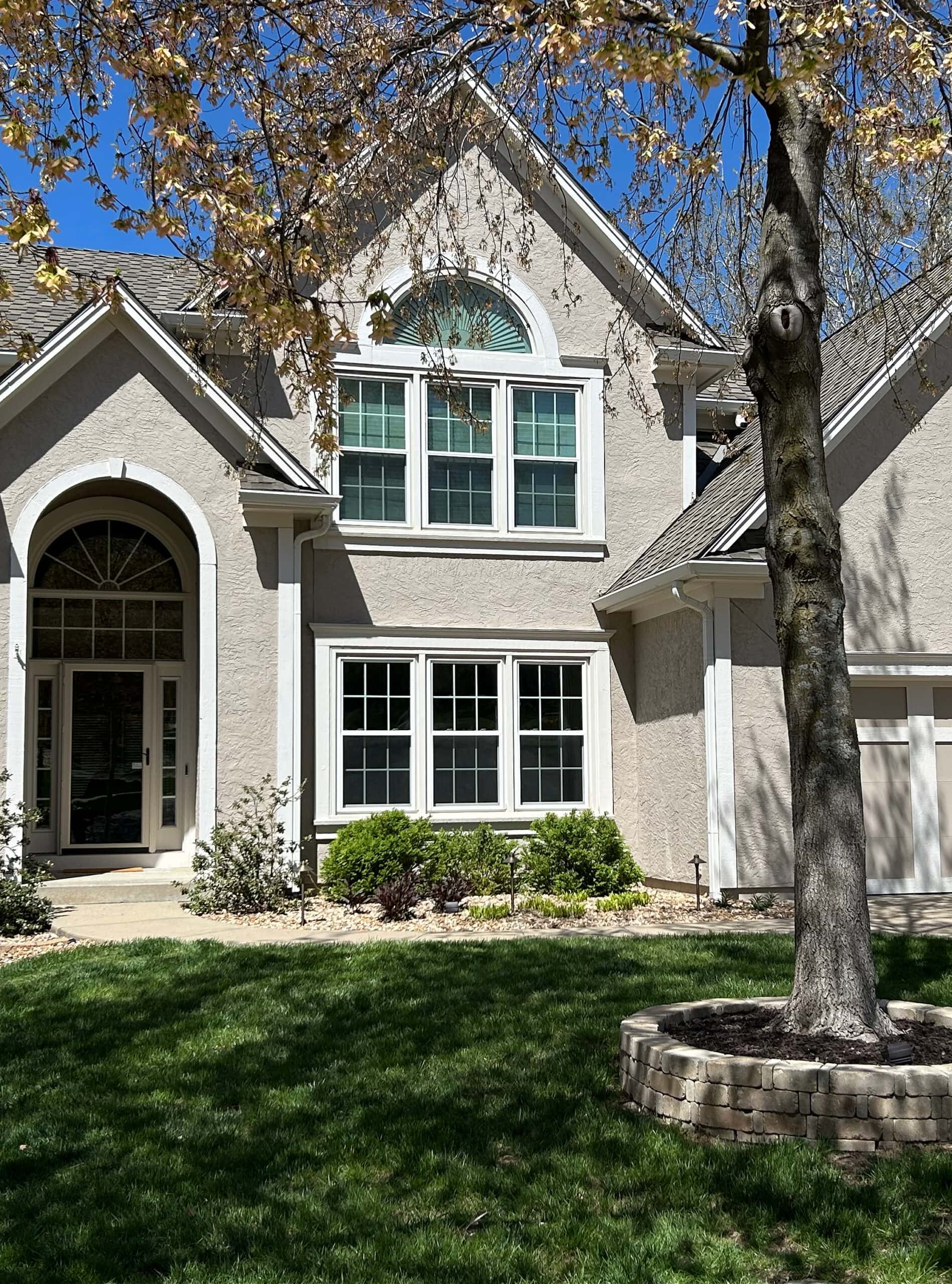 Sherwin Williams Balanced Beige exterior stucco paiont color, Aesthetic White trim color and garage door details, brick accents (2)