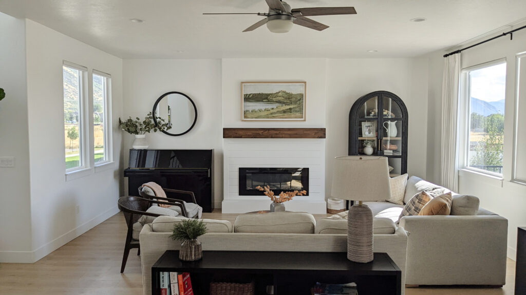 Living room, transitional style, home decor, black piano, shiplap fireplace accent, arched cabinets, neutral off-white sofas, Sherwin Williams Pure White walls