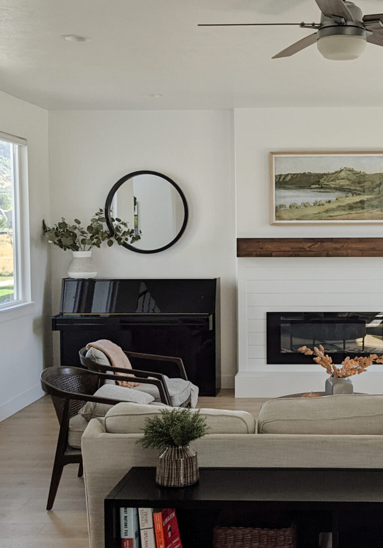 Sherwin Williams Pure White, transitional home and living room with decor, art and black piano, shiplap accent on fireplace
