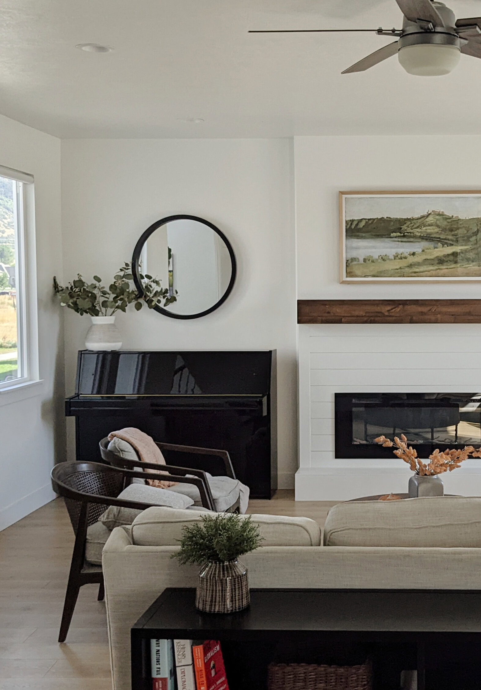 Sherwin Williams Pure White, transitional home and living room with decor, art and black piano, shiplap accent on fireplace