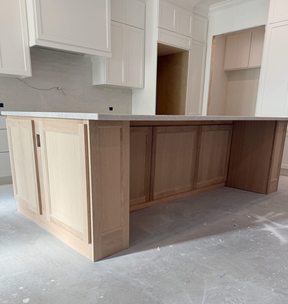 white oak in Classic Gray and Weathered Oak stain with quartzite island and Alabaster cabinets