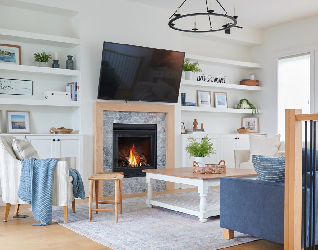 Benjamin Moore White Dove, best warm white paint color, home decor for lake style home design, builtins, blue sofa, marble fireplace surround, white oak mantel and furnishings,
