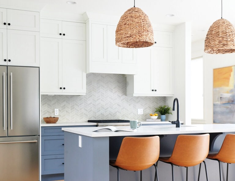 Benjamin Moore White Dove kitchen cabinets, Britannnia Blue island and lower cabinets, rattan pendant lights, leather counter stools, stainless steel.
