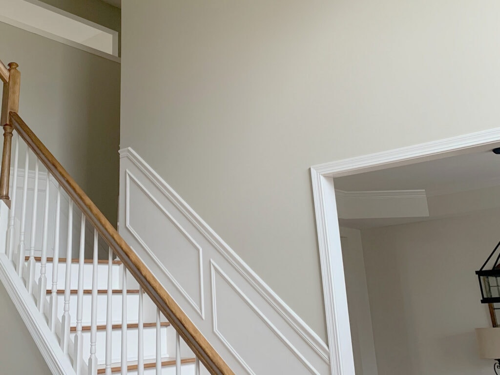 Best beige or tan 2026 paint colour, Benjamin Moore Grant Beige. Staircase, wood and white. Kylie M Interiors Edesign, online paint color best timeless advice blog