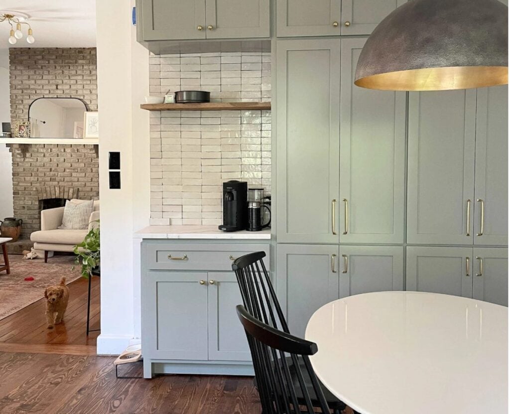 Farrow and BAll Pigeon, green-gray paint color on painted kitchen cabinets, Zellige tile backsplash, wood floor, gold hardware