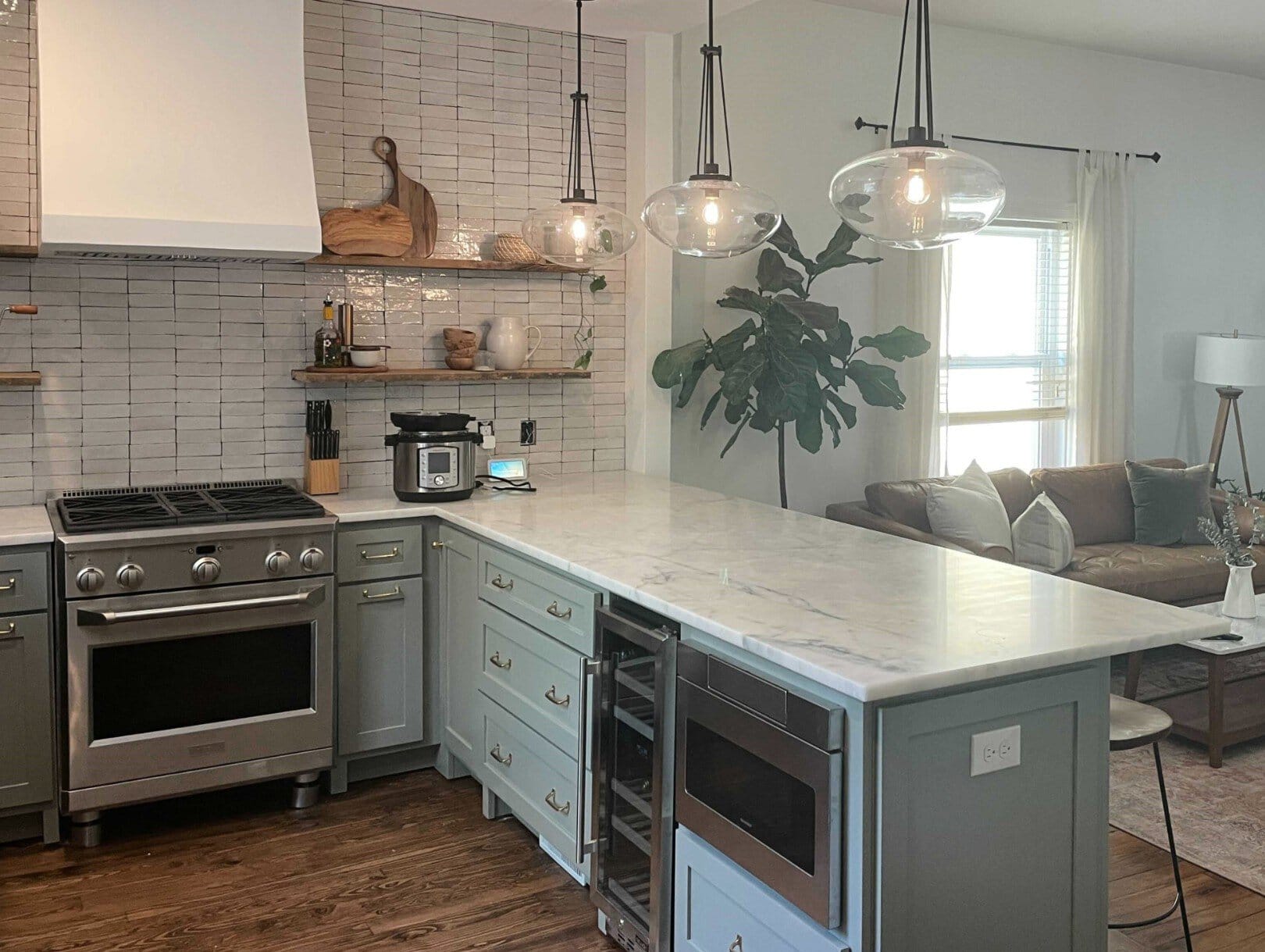 Farrow and Ball Pigeon, green gray paint color, painted wood kitchen cabinets, gold hardware, quartz or marble countertop, Zellige tile, brick fireplace