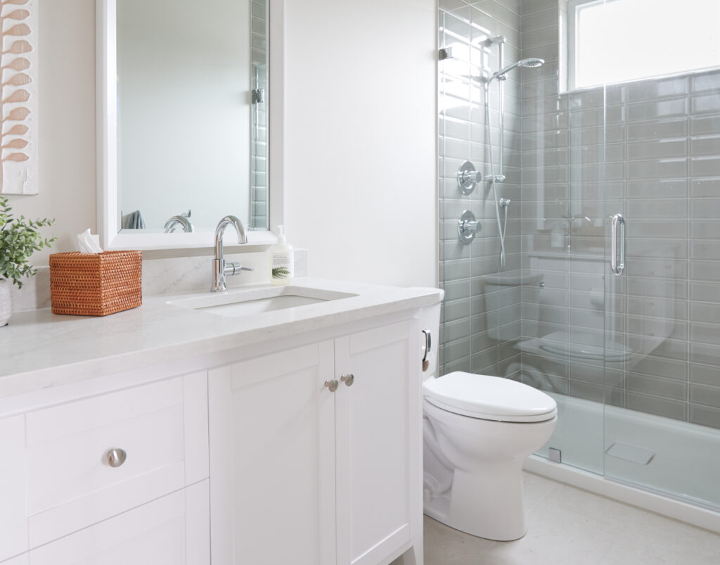 Sherwin Williams Aesthetic White, off-white beige paint color on bathroom walls, walk in shower, acrylic base, green-gray subway tile surround, white vanity, Omnia quartz, beige tile