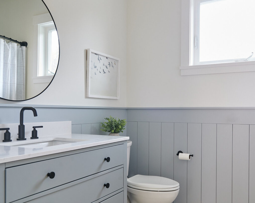 Sherwin Williams Network Gray on painted lower vertical shiplap in bathroom, gray vanity, black hardware, Benjamin MOore White Dove upper walls