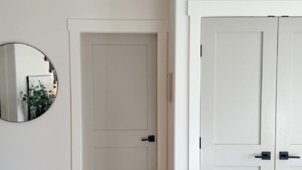 Benjamin Moore Revere Pewter on painted interior doors, White Dove trim and walls, black hardware, oak flooring in south-facing light