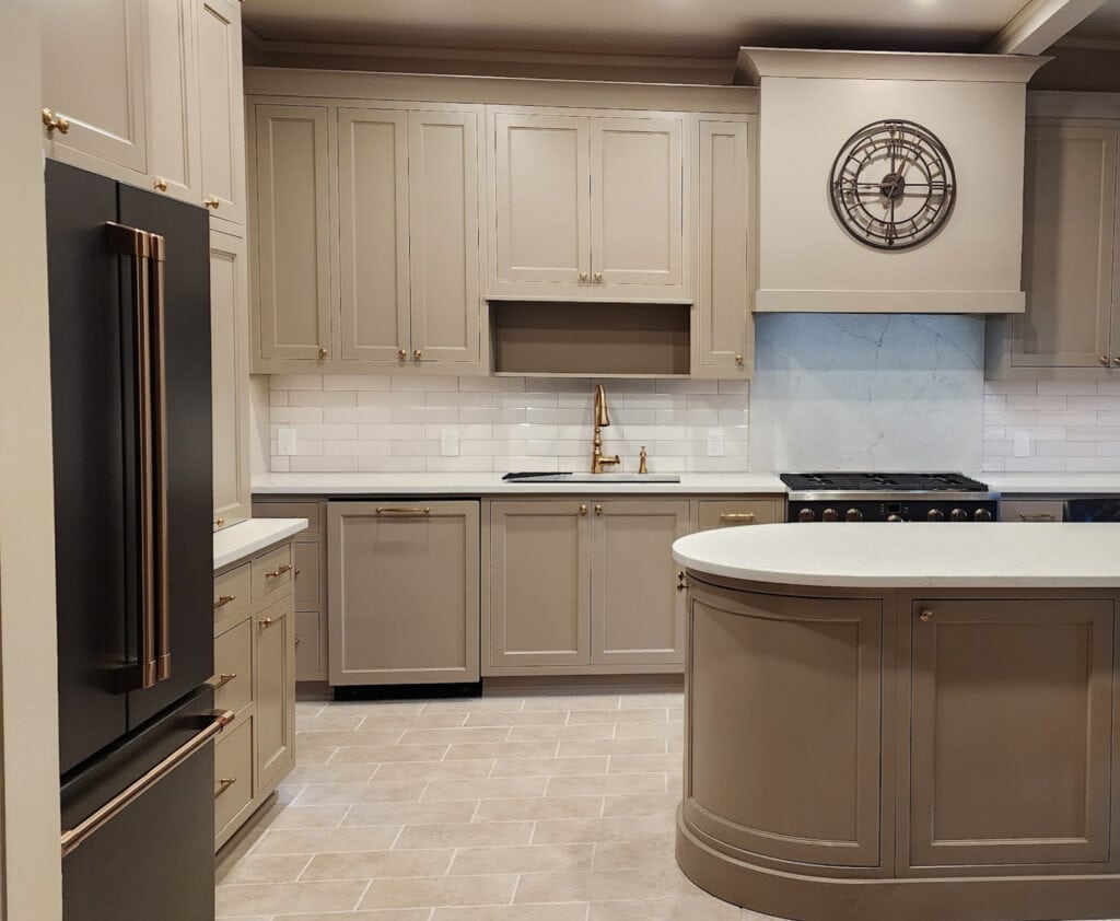 Cashmere kitchen, mushroom painted cabinets, Sherwin Williams Warm Stone lighter, travertine tile floor, Ge Cafe Matte Black appliances, zellige tile backsplash, gold hardware,