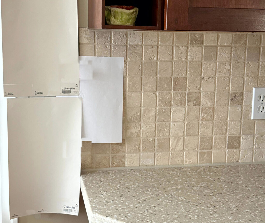 Samplize peel and stick paint samples, popular shades of beige with travertine tile backsplash, cherry, red stained wood cabinets, beige countertop