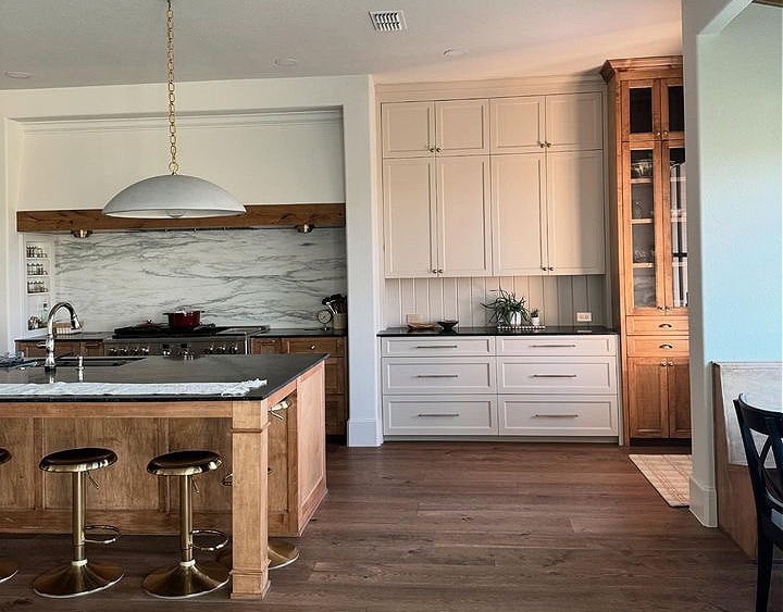 Sherwin Williams Accessible Beige painted cabinets, cashmere kitchen color, Aesthetic White walls, wood stained island and floor, black quartz countertops, slab backsplash
