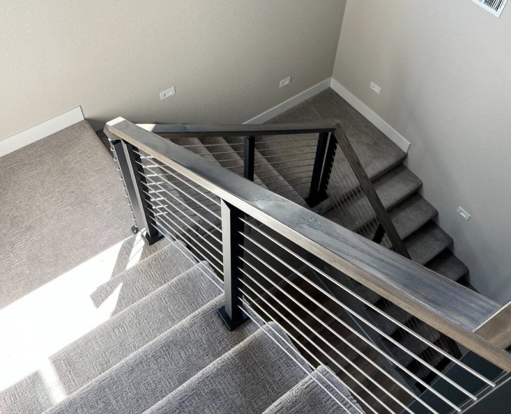 Sherwin Williams Alpaca, warm gray taupe with gray carpet on staircase, wood and metal modern railing, horizontal