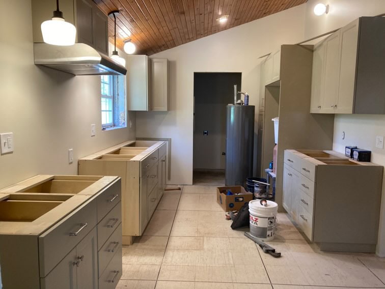 Sherwin Williams Universal Khaki, dark tan painted kitchen cabinets, wood vaulted ceiling,