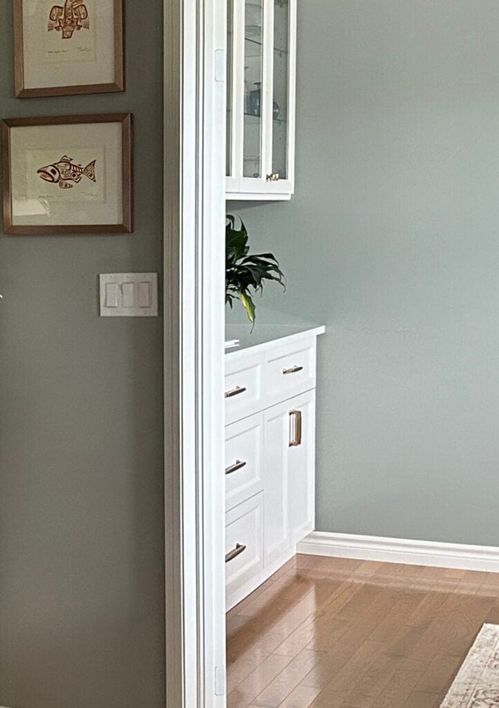 BEnjamin Moore Gray Horse on the wals with golden or red oak flooring and white buffet style cabinets