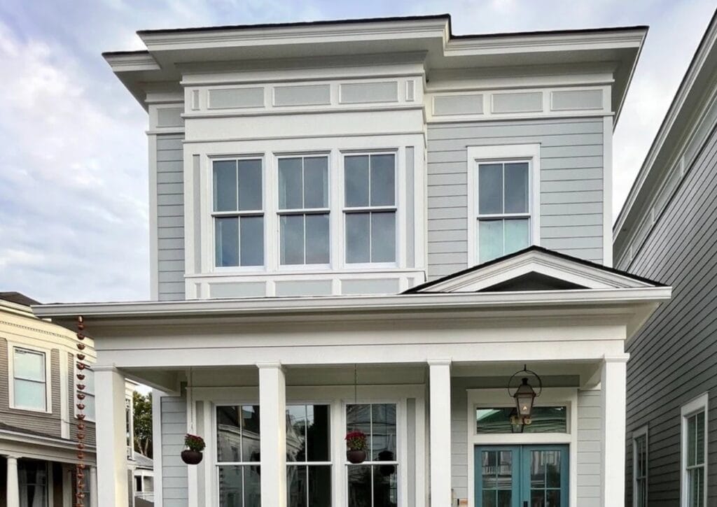 Bella Blue painted front door, Benjamin Moore Half Moon Crest gray-blue-green exterior siding, Pure White trim, flat roof, white gutters and windows - Copy