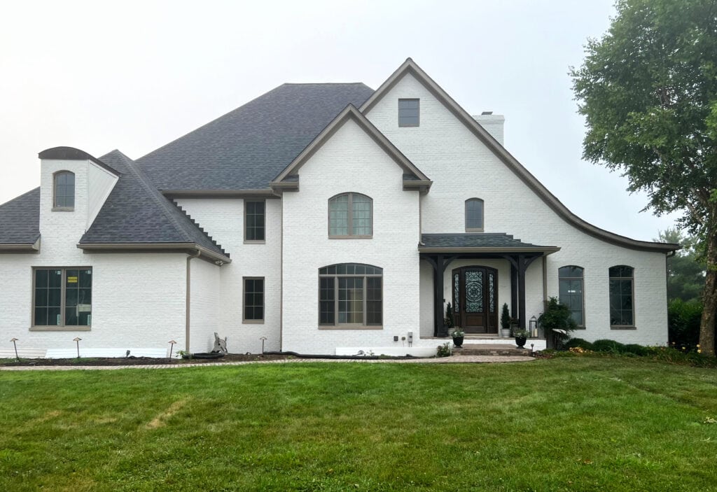 Benjamin Moore Seapearl, 2 story home best warm off-white for painted brick exterior, brown trim, painted windows, portico over front door