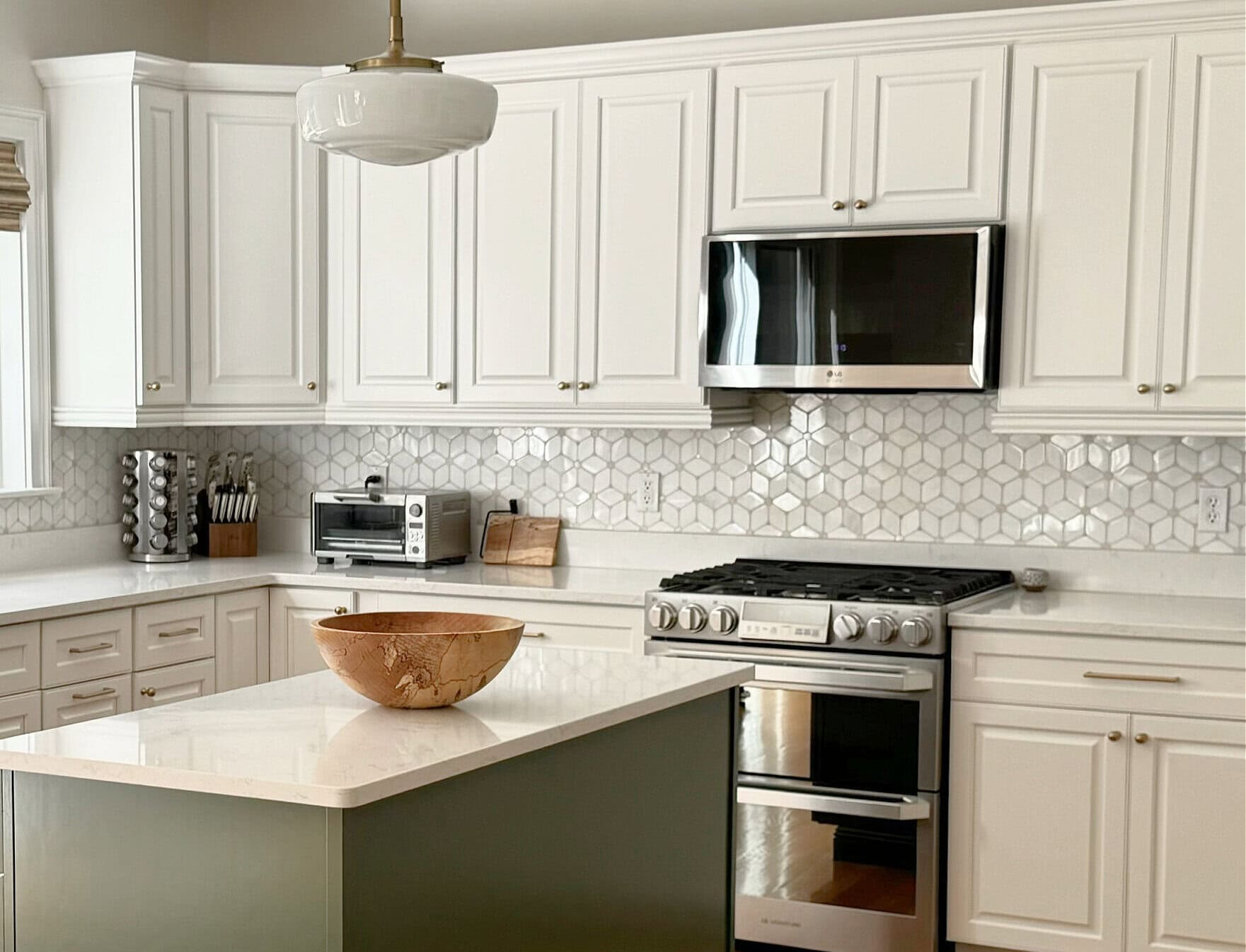 Benjamin Moore White Dove painted kitchen wood cabinets, Peale Green island, white quartz, patterned tile marble backsplash, golden oak flooring, Pearly White (Sherwin) walls