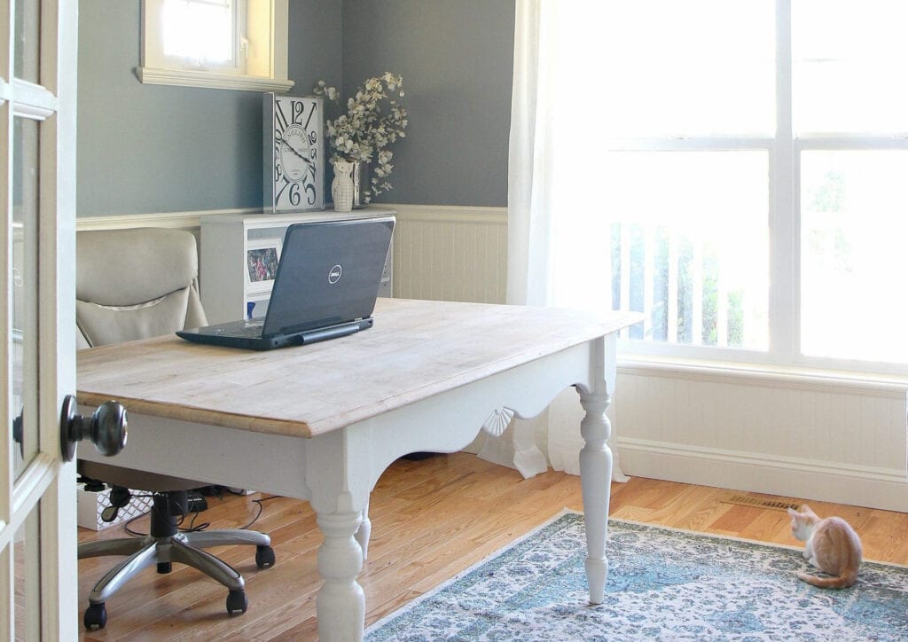 Home office with golden oak floor, BEnjamin Moore Stonybrook paint on walls, cream trim and desk