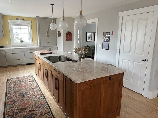 Kitchen with white oak, wood island, Sherwin Williams Repose Gray walls and Pavestone painted cabinets, Taj Mahal quartzite counter