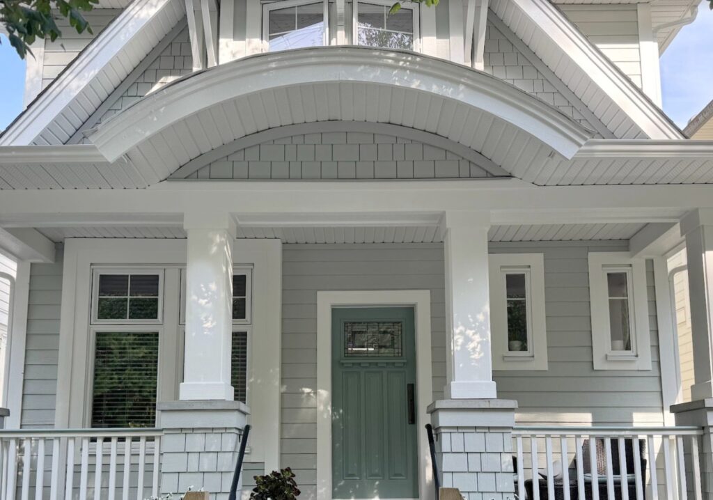 Sherwin Williams Pure White on exterior trim, white windows, Rushing River, blue-green front door, Gray Horse painted siding and shakes, curved portico