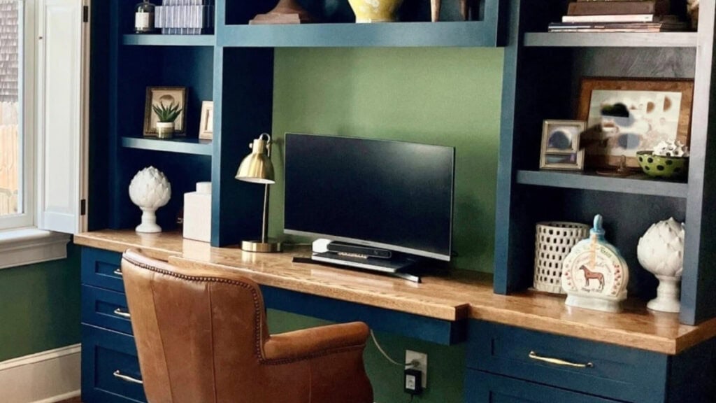 home office with wall painted Farrow and Ball Calke Green, desk is painted Hague Blue. Wood countertop
