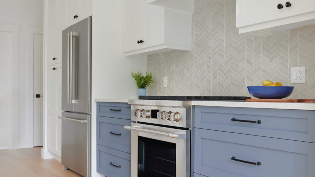 Benjamin MOore White Dove kitchen cabinets and chevron pattern tile backsplash, Britannia Blue lower cabinets and island and leather stools (1)