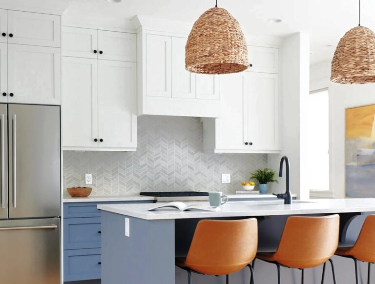 Benjamin MOore White Dove kitchen cabinets, chevron pattern tile backsplash, Britannia Blue lower cabinets and island and leather stools