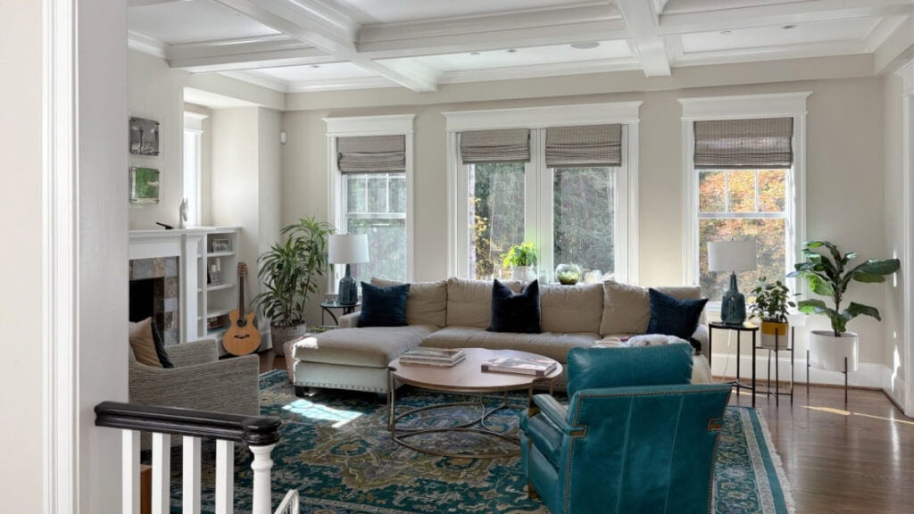 Benjamin Moore Edgecomb Gray for a whole home neutral, shown in large living room with teal accents and white dove trim and coffered ceiling