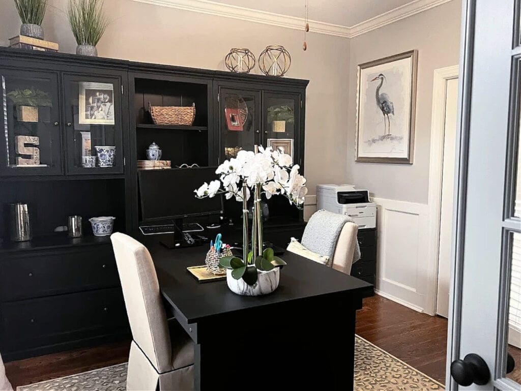 Home office with two chairs, black bookcases and desk. Sherwin Williams AGreeable Gray on the walls with Alabaster trim
