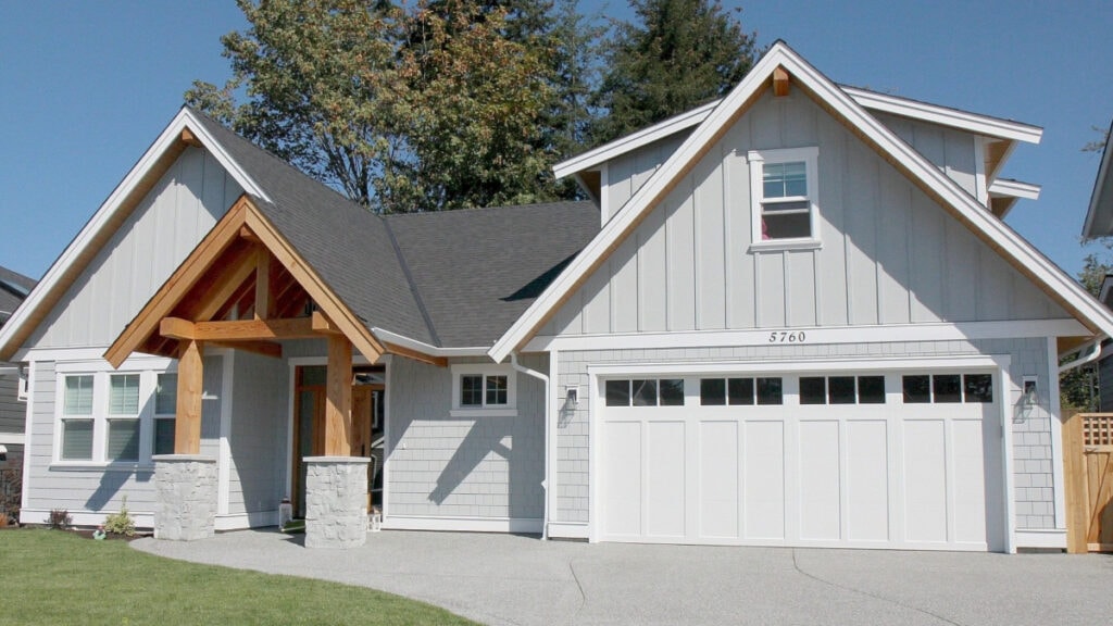 exterior, James Hardie in LIght Mist with Sherwin Williams High Reflective White trims, gutters and garage door. Wood beams, soffits and front door