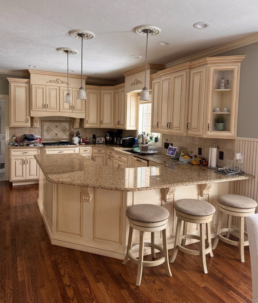 Sherwin Williams Antique White glazed (cream) kitchen cabinets with Horizon Gray paint color on walls, granite countertop