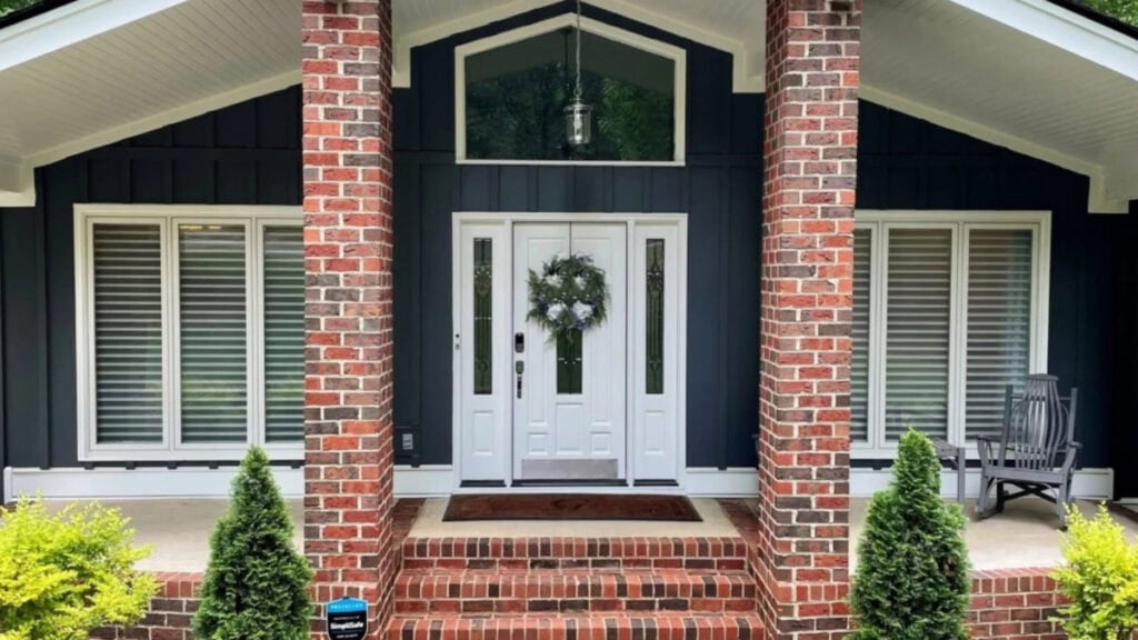 James Hardie Iron Gray board and batten exterior siding, red and gray brick Sheriwn williams Extra White trim