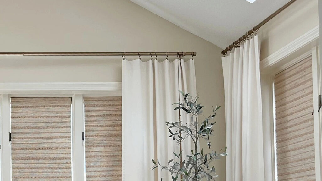 Benjamin Moore Natural Wicker in a sunroom with drapes, yellow sofa and home decor