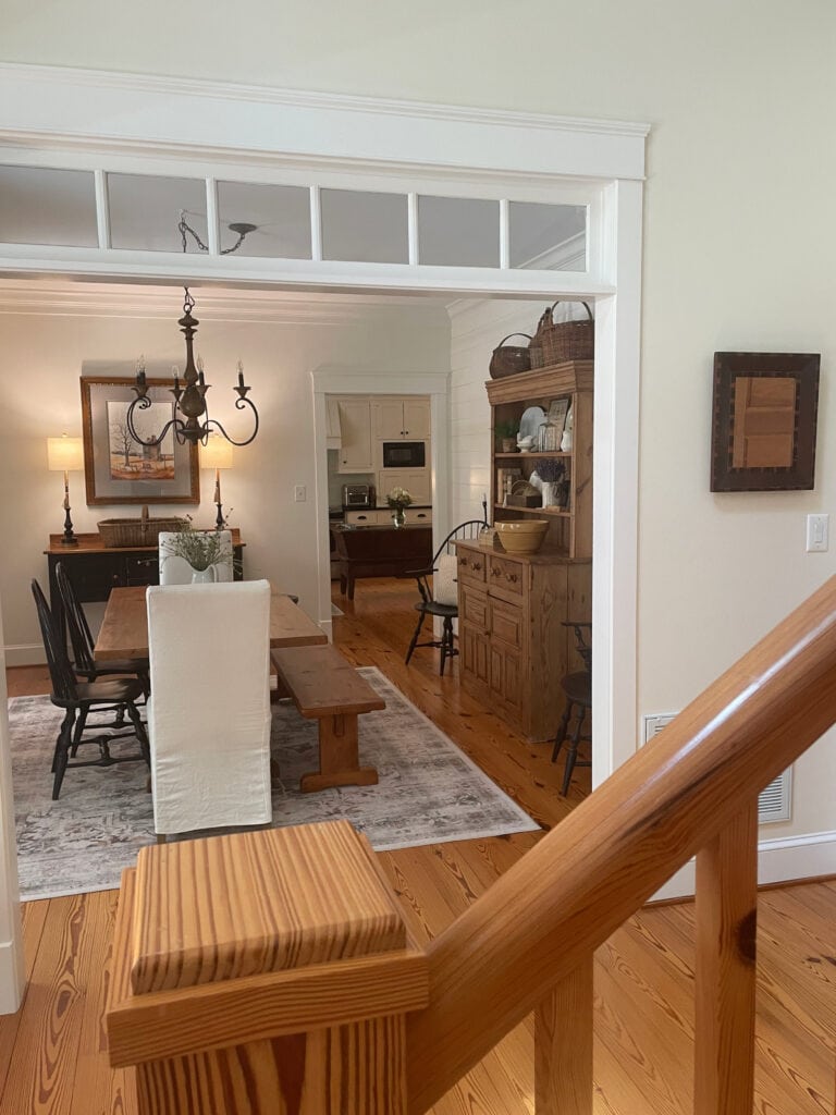 Cream walls in entryway, BEnjamin Moore Navajo White, heart pine wood floors, modern country farmhouse dining room in White Dove, south-facing light