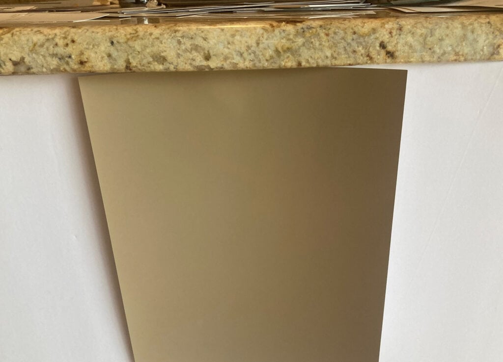 Sherwin Williams Antler Velvet sample with 2000s granite countertop